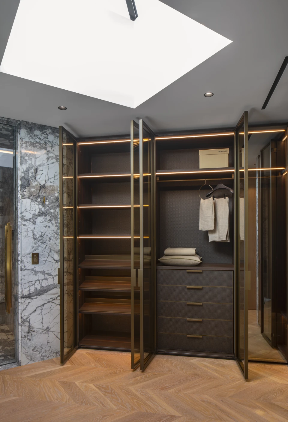 A walk-in closet, lit from a skylight above