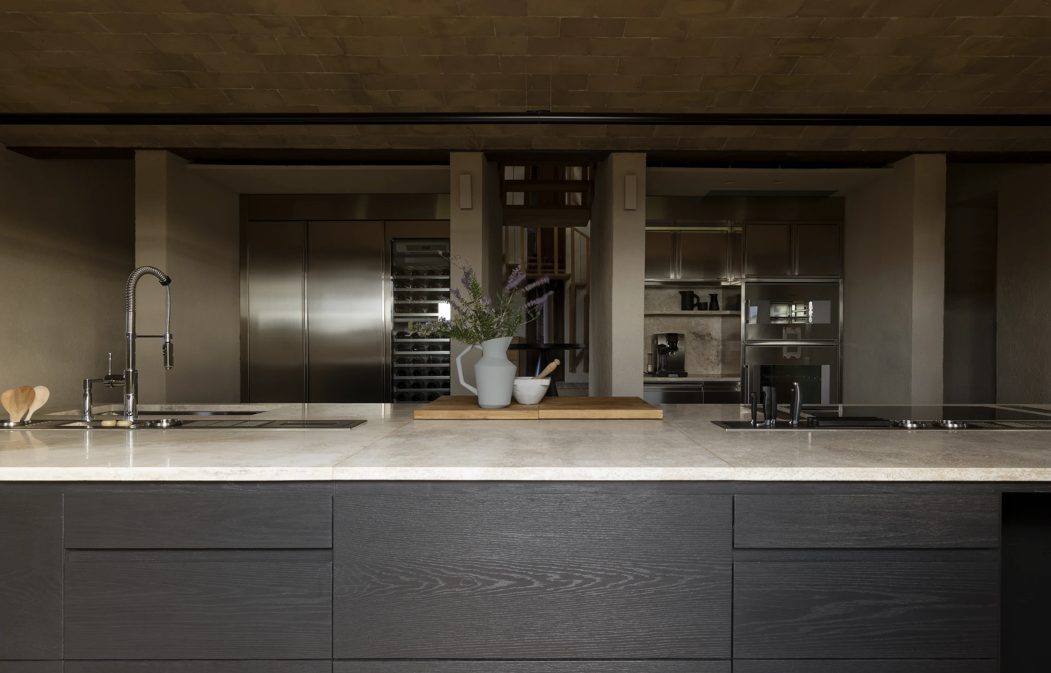 The kitchen, under a vaulted brick ceiling