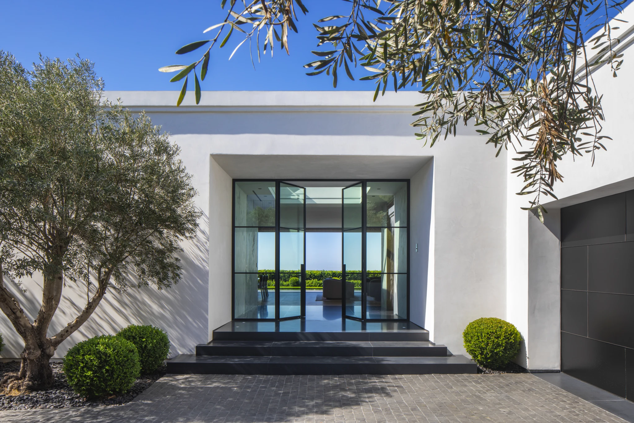 The entrance court, with an olive tree against white stucco