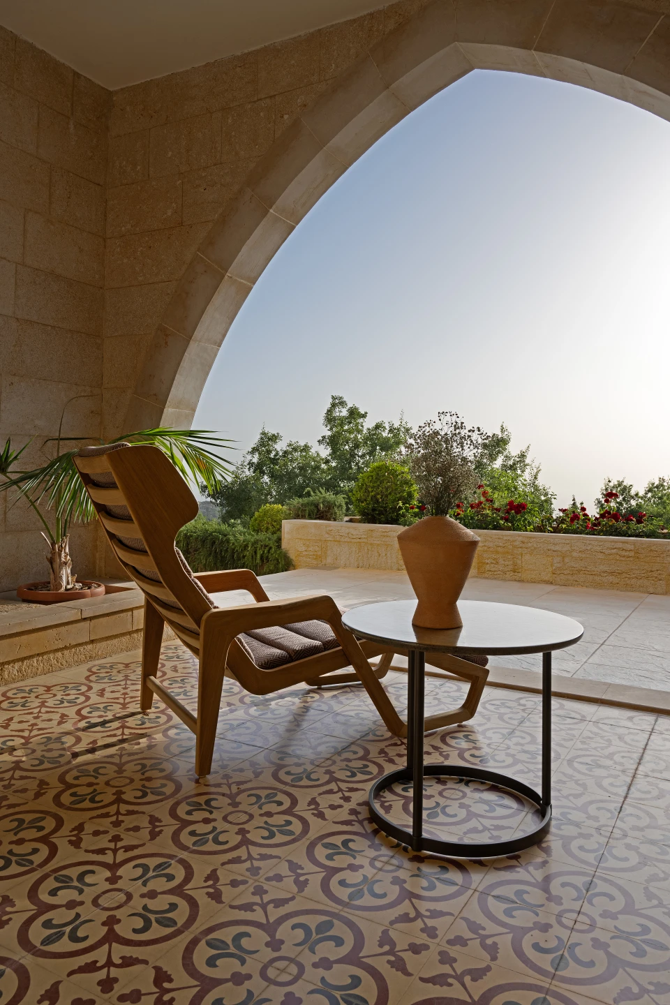 Under the arch, on the villa's patterned floor tiles